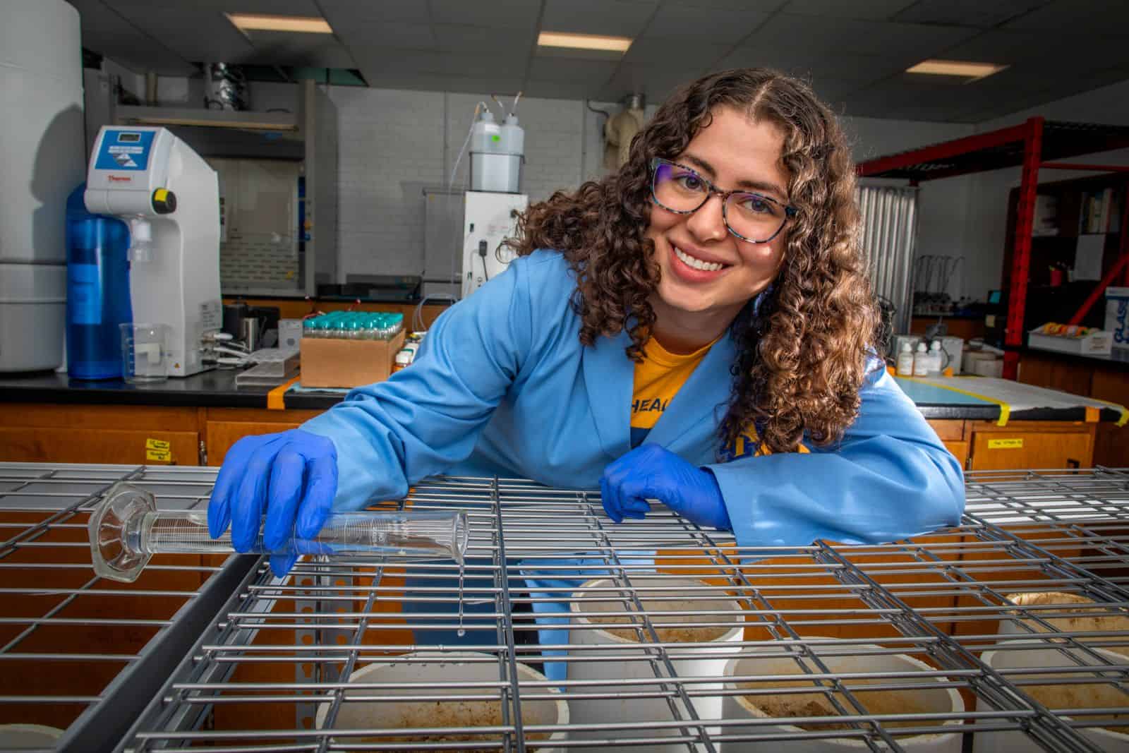 Microbiologist working in laboratory with petri dishes and scientific equipment Microbiologist in lab handling petri dishes and scientific instruments for research.